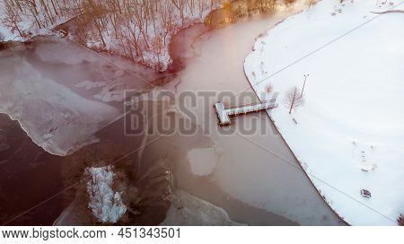 Aerial View Of Union Pond Frozen In Snow Seen During Sunrise