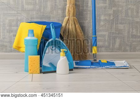 A Home Cleaning Kit On The Floor Near The Wall. Home And Office Cleaning Kit. The Concept Of Maintai