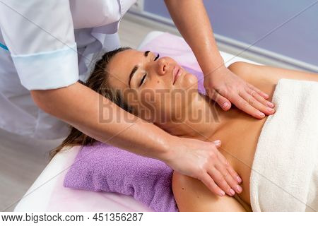 Facial Massage. A Woman Is Given A Massage In A Beauty Salon. Close-up.