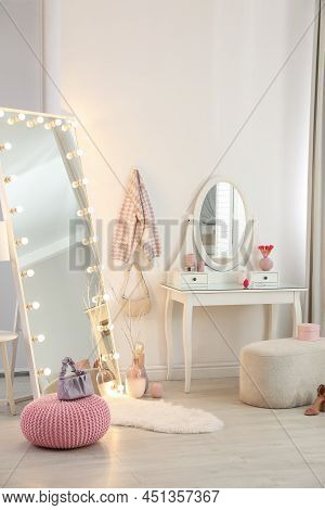 Large Mirror With Light Bulbs And Dressing Table In Stylish Room. Interior Design