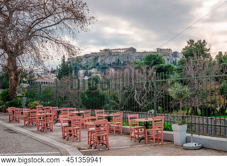 Sidewalk Cafe In Adrianou St, Next To The Ancient Agora, With The Historic District Of Plaka And The