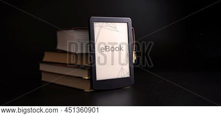 E Reader. Digital E Book, Library Reader Tablet With Books On Dark Background. Online Education Cour