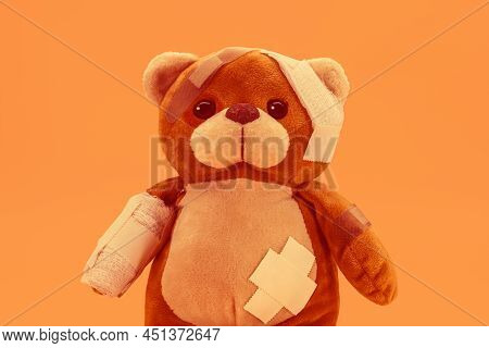 Teddy Bear Toy With Bandages And Bandages, Image In Orange Tone For The Month Of May Orange, About P