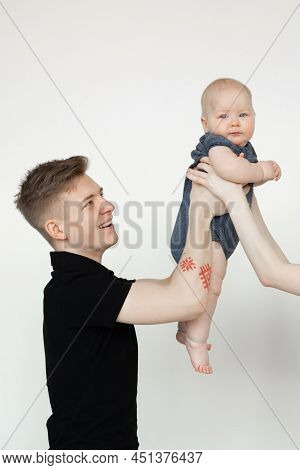 Vertical Shot Of Glad Young Man, Father, Holding Cute Little Baby, Caring Woman Hands. Surrogate Mat