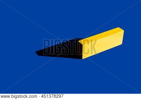 Bright Yellow Tetragonal Block On Blue Background With Shadow, Ukrainian Concept.