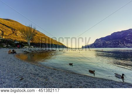 Nago-torbole, Italy - February 26, 2022: View Of The North Shore Of Lake Garda, With Locals And Visi
