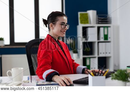 Smiling Startup Owner With Glasses Working At Desk In Office. Happy Small Business Owner With Glasse