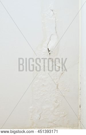 The White Paint Wall Is Peeling And A Long Crack Near The Corner Of The Bedroom, Rain And Humidity F