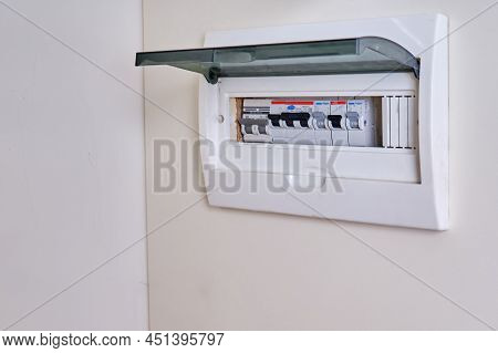 Automatic Fusein A Home Electrical Panel In The Closet With Clothes. Electricity Equipment In The Ap