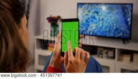 Woman Using Smartphone With Green Screen For Copy Space Chroma Key Mock Up With Tracking Markers And