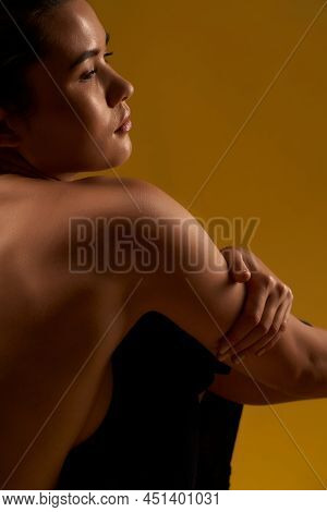 View From Shoulder Of Pretty Young Female Sitting Backwards On Floor, Yoga Doing. Beautiful Brunette