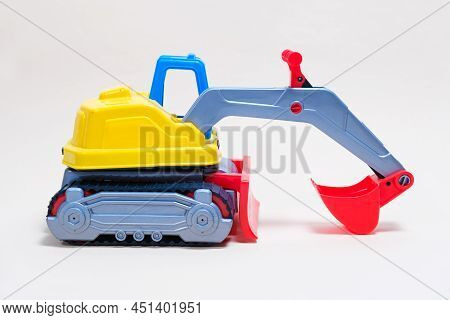 Yellow Excavator Plastic Car On White Background. Construction Machinery Car For Digging For Toy Sto