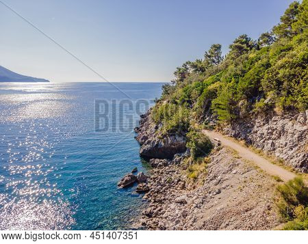 Picturesque Sea Adriatic Coast Of Montenegro. Turquoise Mediteran Sea And Rocky Shore With Evergreen