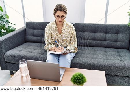 Young hispanic woman having pshychology teleconsultation at psychology clinic
