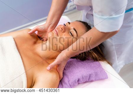 Facial Massage. A Woman Is Given A Massage In A Beauty Salon. Close-up.