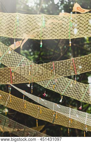 Golden Dharmacakra Flags Near An Ancient Buddhist Pagoda In A Deep Forest, The Symbol Of Buddhism In
