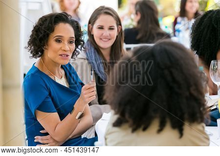Ladies Networking At Woman's Team-building Luncheon In Garden Cafe
