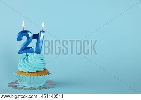 Delicious Cupcake With Number Shaped Candles On Light Blue Background, Space For Text. Coming Of Age