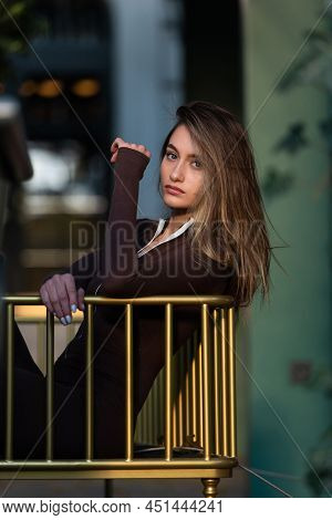 Portrait Of A Fashionable Young Brunette Woman Wearing Solid Long Sleeve Bodycon One Piece Jumpsuits