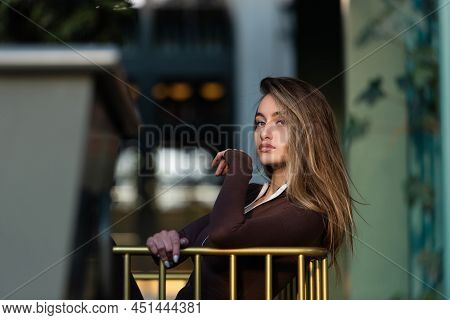 Portrait Of A Fashionable Young Brunette Woman Wearing Solid Long Sleeve Bodycon One Piece Jumpsuits