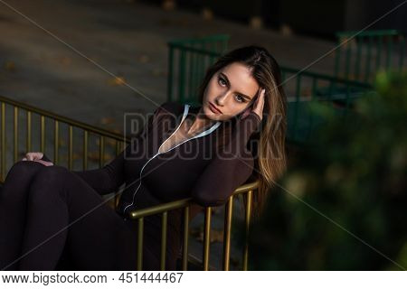 Portrait Of A Fashionable Young Brunette Woman Wearing Solid Long Sleeve Bodycon One Piece Jumpsuits