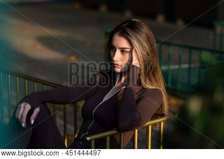 Portrait Of A Fashionable Young Brunette Woman Wearing Solid Long Sleeve Bodycon One Piece Jumpsuits