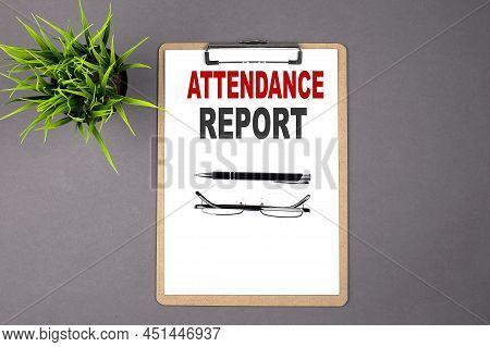 Attendance Report On Brown Clipboard On The Grey Background. Business Concept