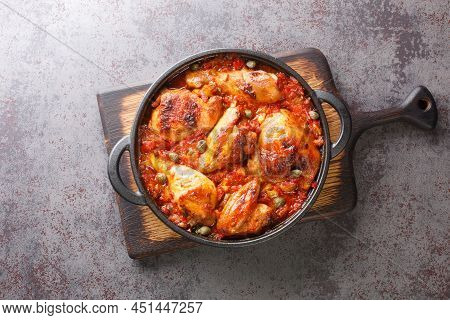 Spanish Food Chicken Baked With Tomato, Pepper, Onion And Garlic Sauce Close-up In A Frying Pan On A