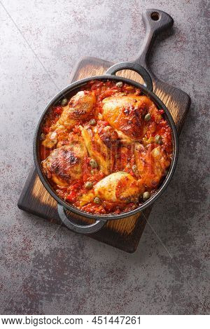 Baked Chicken With Sofrito Vegetable Sauce Close-up In A Frying Pan On The Table. Vertical Top View 
