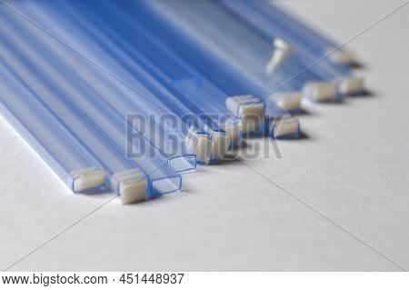 Batch Of Empty Tubes For Surface Mount Components In Microelectronics Industry Production.