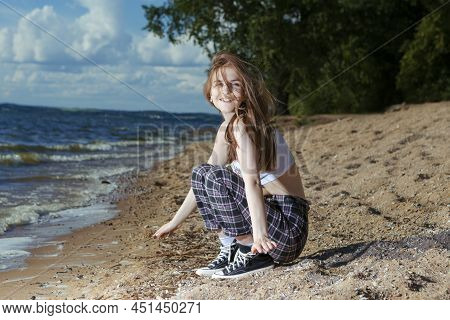 Young Happy Smiling Caucasian Brunette Girl Posing In Beach Clothing While Resting And Having Fun At