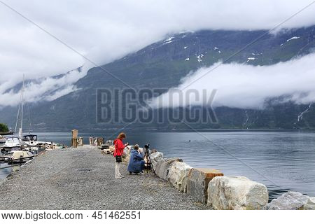 Ullensvang, Norway - July 30, 2020: Photography Enthusiast Takes Photos With A Tripod In Ullensvang.