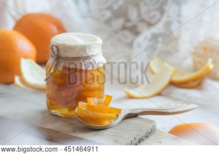 Homemade Candied Peels Orange Confiture In Glass Jar On Light Background, Selective Focus