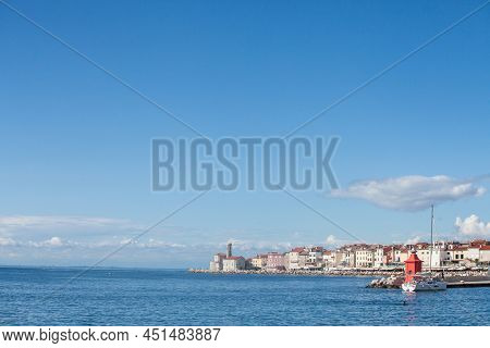 Panorama Of  Piran, Slovenia, With The Adriatic Sea In Front, With Blue Water And Sky, On A Wharf An