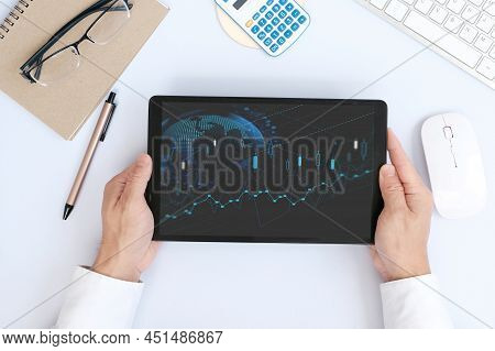 Hand Using Tablet And Analysing Banking And Investment Growth Graph To Develop Smart Financial Decis