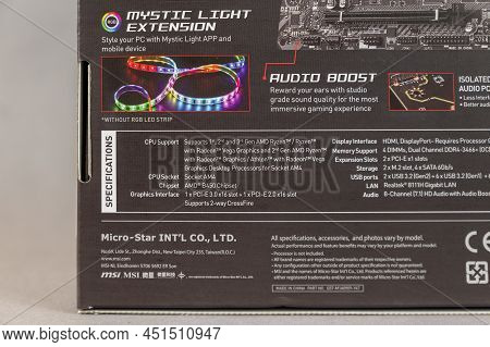 Msi B450 Mortal Max Motherboard Against A Gray Background. Black Box With The New Computer Hardware.