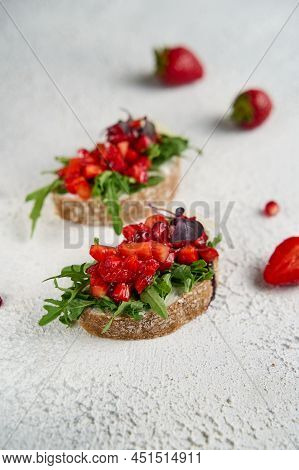 Two Bruscettas With Strawberry On Wooden Background