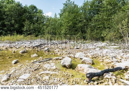 Panoramic Landscape View Over The Small Lake And Natural Surroundigs With A Beach And Woods Around T