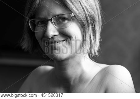 Smiling White Thrity Year Old Woman With Bare Shoulders And Glasses, Brussels