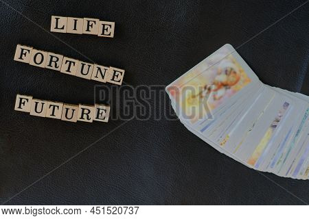 Close-up Stack Of Tarot Cards And Wooden Letters On Message For Communication About What People Want