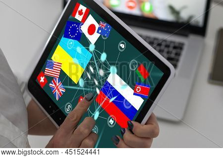 Ukrainian And Russian Flag On A Tablet And Inscription Attack.