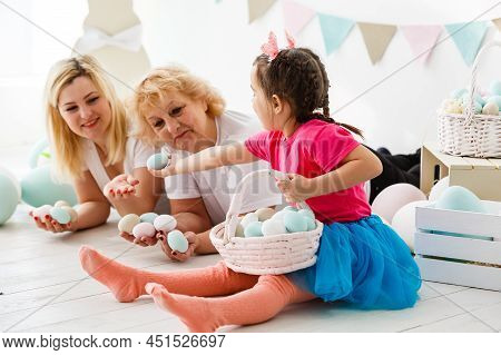 Happy Family With Easter Eggs. Happy Llittle Girl And Grandmother With Easter Eggs