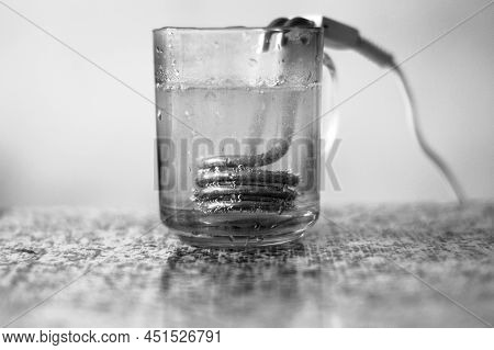 Hot Water With Bubbles In A Transparent Cup