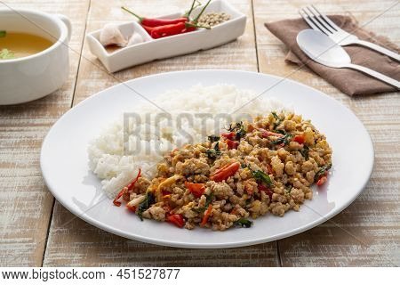 Stir Fried Pork And Basil,fry Minced Pork And Basil With Oyster Sauce In White Plate With Cooked Tha