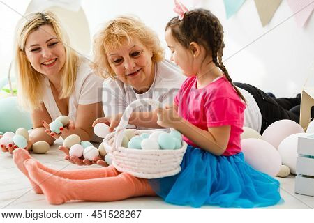 Easter Concept. Happy Llittle Girl And Grandmother With Easter Eggs