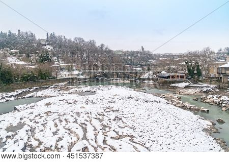 Kutaisi, Georgia - March 17, 2022: View From White Bridge On Rocky Mountain Rioni River In Kutaisi, 
