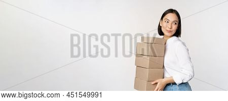 Portrait Of Young Asian Woman Holding Boxes, Carry Delivery Goods. Korean Female Entrepreneur Assemb