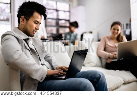 Young Diverse People Working In Coliving Space