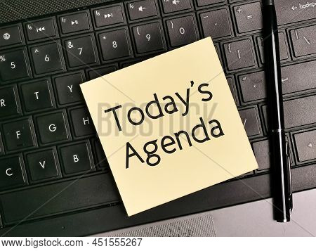 Top View Image Of Sticky Note Written Today's Agenda With A Pen And Keyboard.