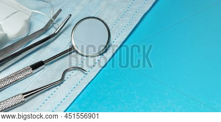 Set Of Medical Dental Equipment And Dental Floos On Blue Background. Copy Space